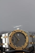 Load image into Gallery viewer, Two-tone Audemars Piguet Royal Oak with a gold bezel, diamond hour markers, and a dark grey waffle-textured dial
