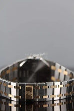 Load image into Gallery viewer, A two-tone metal watch bracelet with a gold clasp

